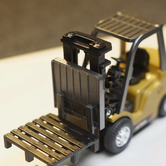 Model of a forklift on a reflective surface with a blurred background