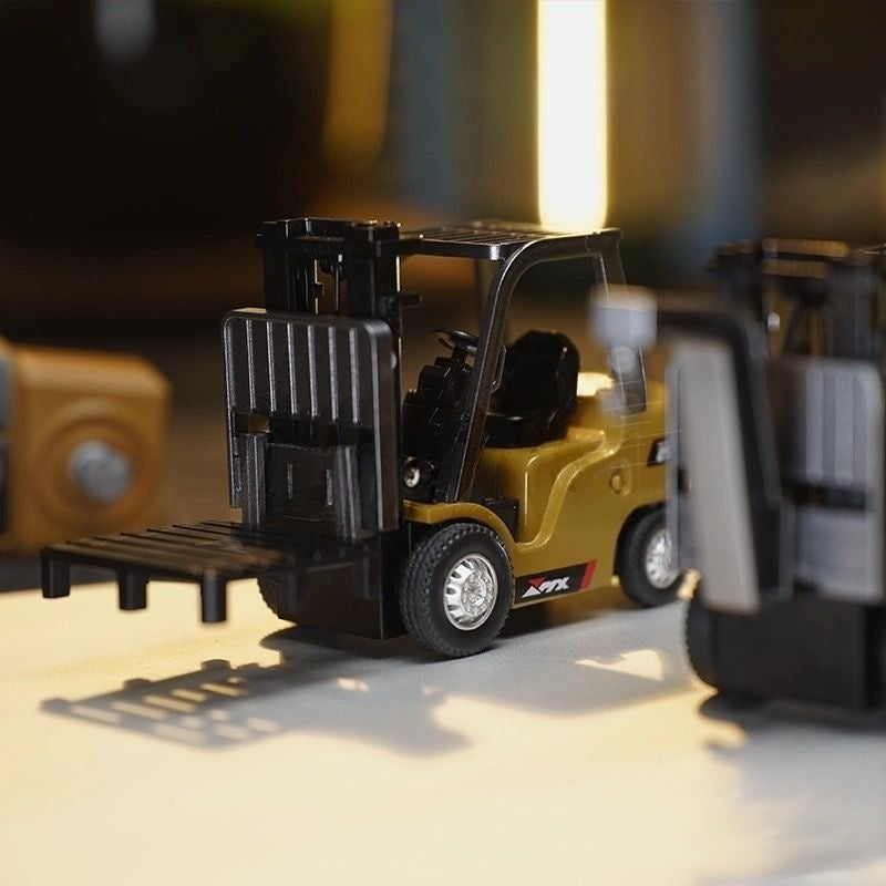 Toy forklift on a reflective surface with a blurred background