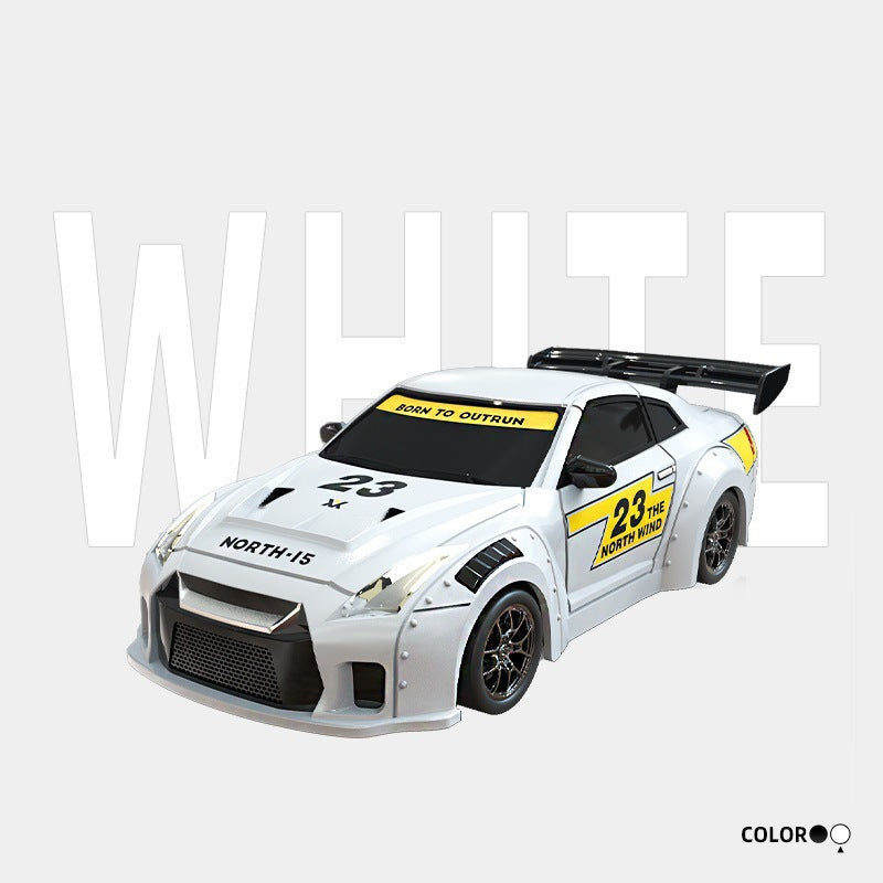 White toy car with black and yellow details on a light gray background
